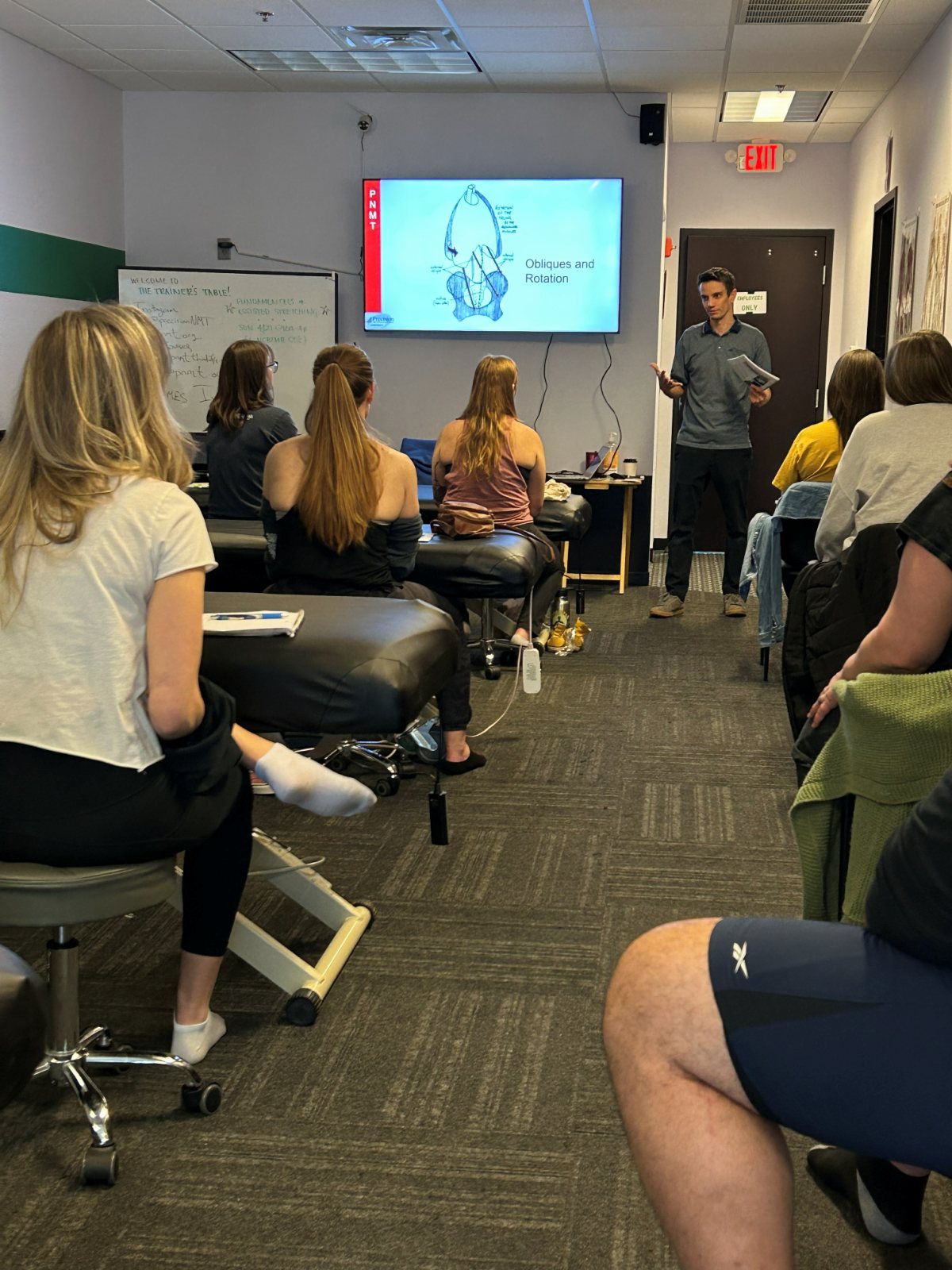 A Precision Neuromuscular Therapy instructor teaching a classroom session at The Trainer's Table